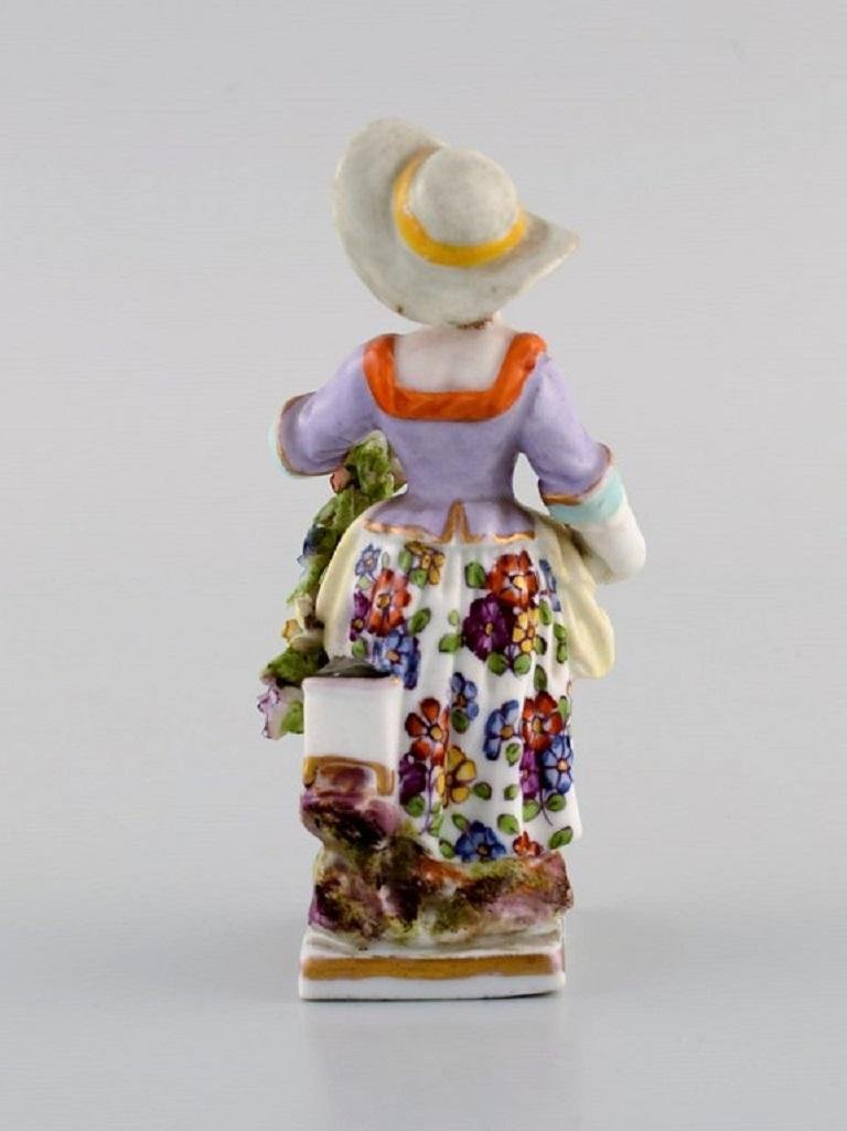 Antique Hand-Painted Porcelain Figure of Girl With Flowers from Augustus Rex, Germany