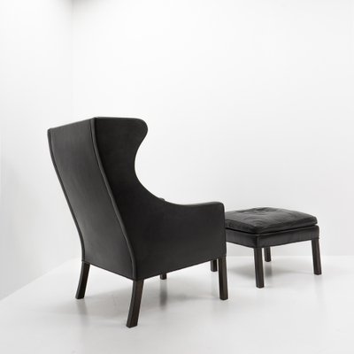 Black Leather Wingchair and Footstool by Borge Mogensen for Fredericia, 1960s, Set of 2-TJQ-1378679