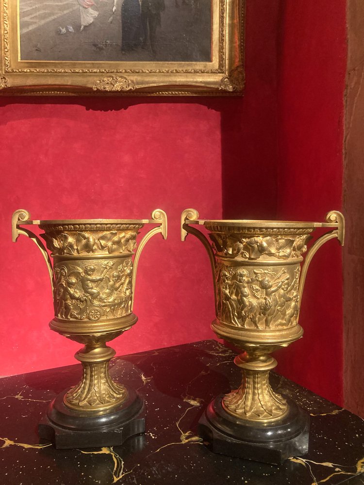 French 18th Century Louis XVI Ormolu Vases with Handles and Relief Putto on Black Belgian Marble Bases, Set of 2