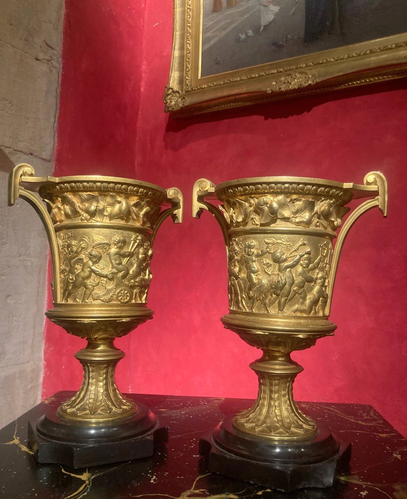 French 18th Century Louis XVI Ormolu Vases with Handles and Relief Putto on Black Belgian Marble Bases, Set of 2