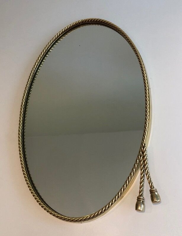 French Oval Brass Mirror with 2 Pompoms in the style of Maison Bagués, 1970s