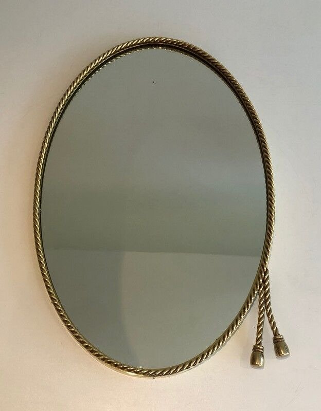 French Oval Brass Mirror with 2 Pompoms in the style of Maison Bagués, 1970s