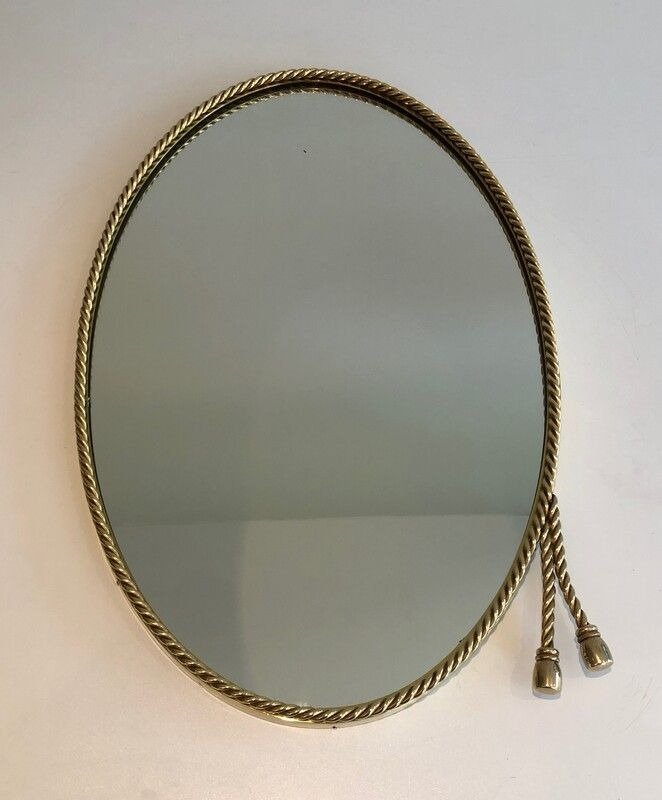 French Oval Brass Mirror with 2 Pompoms in the style of Maison Bagués, 1970s