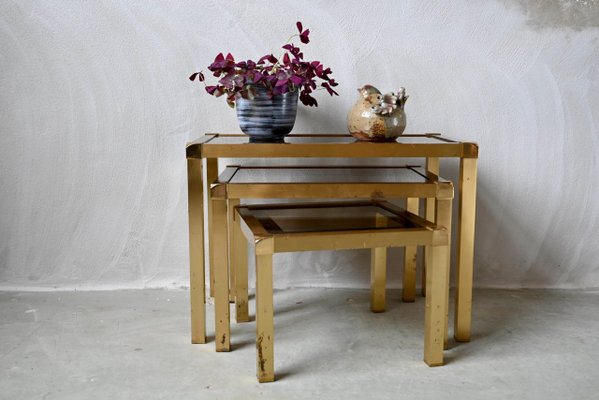 Hollywood Regency Style Nesting Tables or Flying Tables in Gold Metal and Smoked Glass, 1970s, Set of 3-AIU-2016624